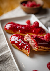 Raspberry eclairs with red raspberry icing