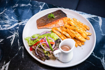 Salmon with fries and vegetables