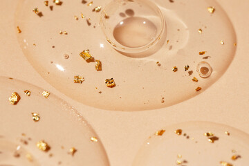 round drops of serum close-up on beige background
