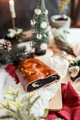Poppy seed roll on the festive table, Scandinavian style, Scandinavian Christmas, candles, Christmas tree