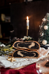 Poppy seed roll on the festive table, Scandinavian style, Scandinavian Christmas, candles, Christmas tree