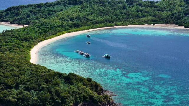 Stunning drone shot of Bulog Dos Island, with its clear blue waters and tropical island beauty.