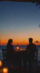 Fototapeta premium Couple enjoying romantic dinner on beach at sunset under starry sky.