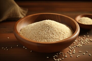 A bowl of white rice is on a wooden table