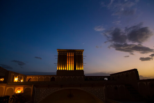 Picturesque view of a wind-catching tower at sunset time in Yazd, Iran. 