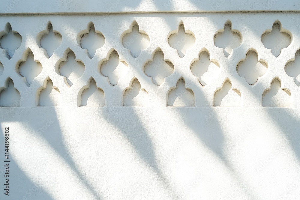 Poster White wall with decorative cutout pattern and light casting shadows.