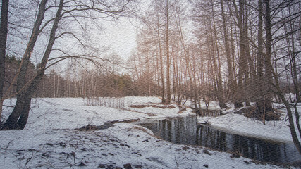 Snowy landscape with a river running through it