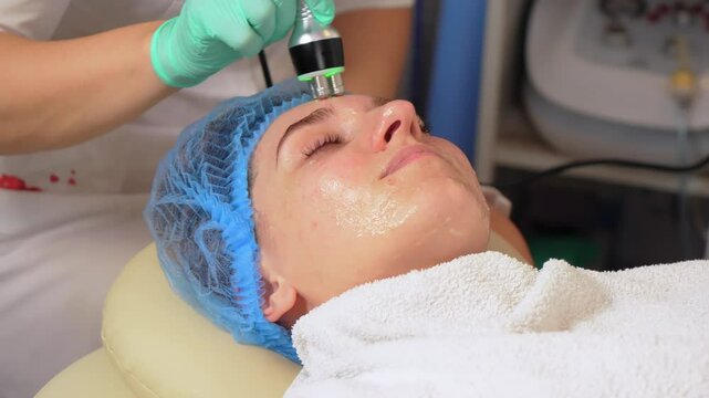 Cosmetological innovations. Skin massage in professional beauty studio. Lifting in beauty. Device for rejuvenation and anti aging facial skin in center of aesthetic cosmetology