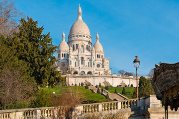 Obraz premium Sacré-Cœur Basilica in Montmartre, Paris, with blue skies and lush surroundings