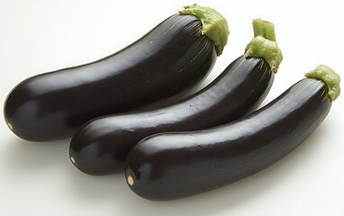 Three ripe, dark purple eggplants arranged on a white background.
