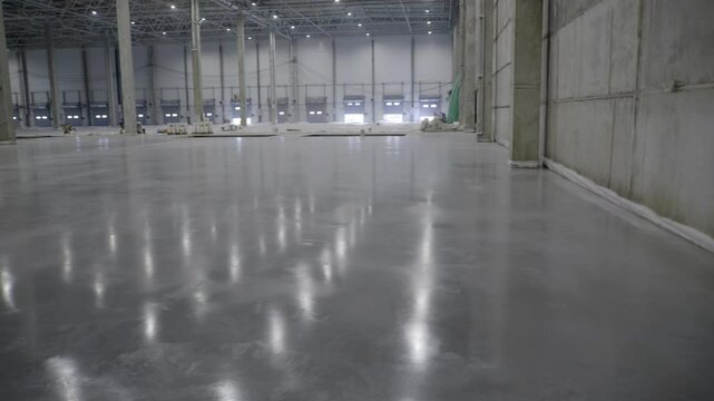 This spacious and expansive industrial warehouse features beautiful polished concrete flooring. Clip