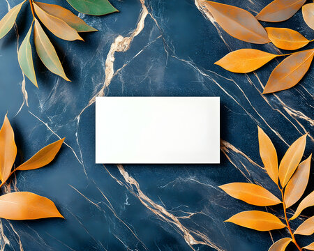Blank business card mockup on marble with autumn leaves for branding.