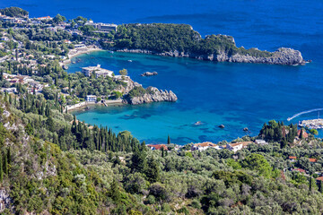 Fototapeta premium Agios Spiridon Beach with crystal clear azure water and white beach in beautiful landscape scenery - paradise coastline of Corfu island at Paleokastritsa, Ionian archipelago, Greece.