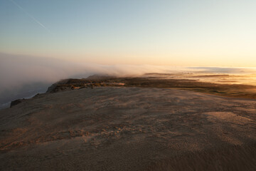 Tower lookout with beautiful sunrise at Lighthouse of Rubjerg Knude. Denmark north coast with wonderfully illuminated sea fog