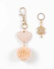 Elegant golden keychain adorned with heart piece and pom-pom, and a luxury diamond clover leaf keyring 