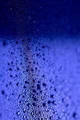 Close Up of Condensation Floating Liquid Water Bubbles and Drips on Glass from Rain