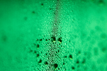 Close Up of Condensation Floating Liquid Water Bubbles and Drips on Glass from Rain