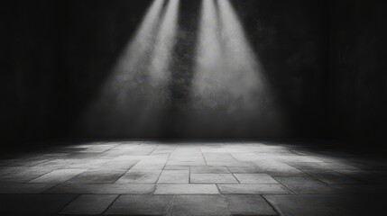 A dimly lit stage with beams of light illuminating the floor, creating a dramatic and atmospheric setting.