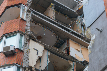 Russian missile hits residential building in Dnipro, Ukraine. Aftermath of enemy attack on city. Destroyed residential multi-story building. Close-up. War. Aftermath of explosion.