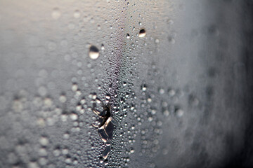 Close Up of Condensation Floating Liquid Water Bubbles and Drips on Glass from Rain