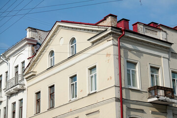Residential building facade with red gutter and chimney