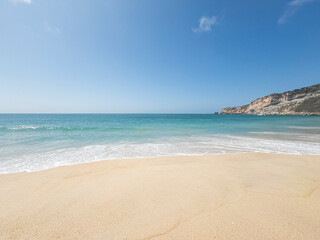 Beach with waves in Nazaré, Portugal. Vacation, surfing, giant waves, tourist destination, summer, surfing and surfer.