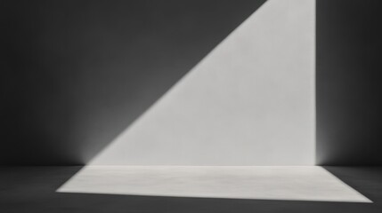 A minimalistic composition featuring a triangle of light against a dark background, creating a striking contrast and an abstract visual effect.