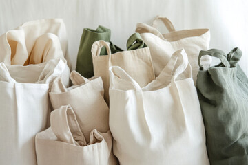 A collection of eco-friendly tote bags in various neutral colors, perfect for shopping or everyday use.