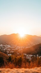 Sunset over city nestled in mountains.