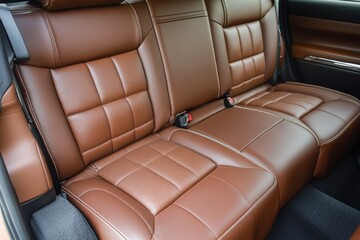 Luxurious brown leather car back seats with detailed stitching and comfort.