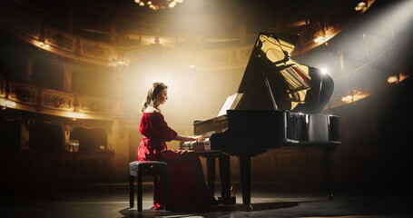 Talented Female Pianist Captivates the Audience with Her Masterful Performance on a Grand Piano. On a Theater Stage, Her Fingers Move Across the Keys, Creating Beautiful Classical Music