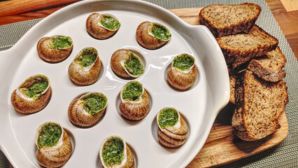 Delicious escargot served with rustic bread on a wooden platter for a cozy dining experience