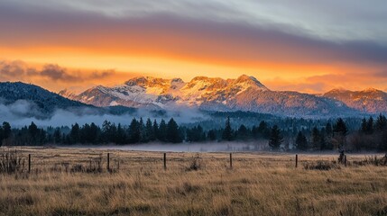 A glowing sunset behind a mountain range, with a hint of mist in the air.