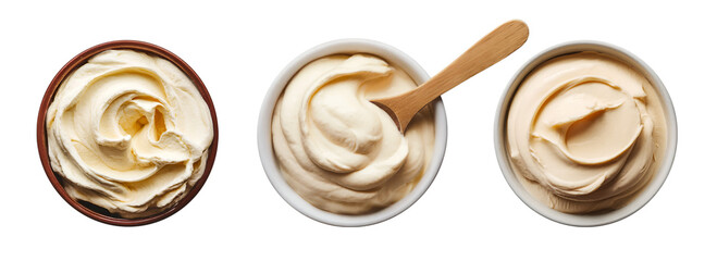 Collection of cut out bowls full of thick creamy product and a wooden spoon. Top view detailed photo isolated on transparent or white background. Food or cosmetic product. 