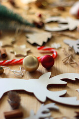 Various Christmas decorations in neutral colors on wooden background. Selective focus.