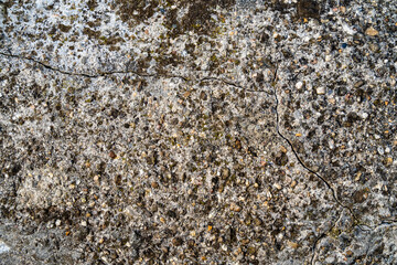 Old concrete with coarse stone and crack as texture.