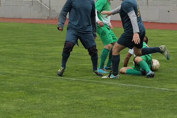 Obraz premium Soccer players on a football field during a foul, conflict during a soccer game, player sent off for breaking the rules in football.