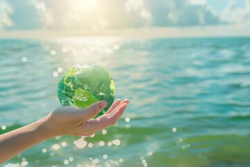 Womans hand holding green planet  water conservation concept.