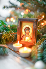 Orthodox Christian icon surrounded by lit candles