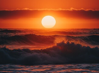 A wide-angle photo of the sun rising above the ocean, where waves are breaking at dawn.