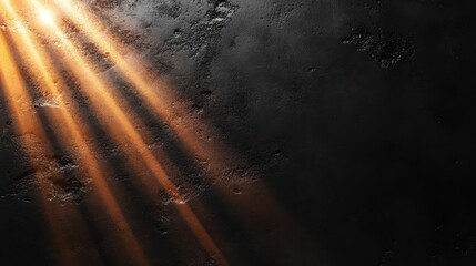 Gentle golden rays of light illuminate a dark textured surface, casting intricate shadows creating an atmosphere of mystery and warmth in solitude.