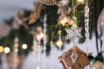 A banner or a beautiful background. Stylish Christmas tree toys in the interior of the house. Green tones. The concept of a stylish new year and Christmas 2025