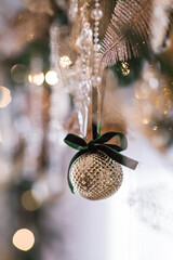 A banner or a beautiful background. Stylish Christmas tree toys in the interior of the house. Green tones. The concept of a stylish new year and Christmas 2025