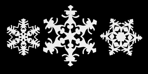 White paper snowflakes isolated on black. Handmade new year decoration