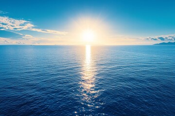 Obraz premium Sunlight glistened on the tranquil ocean. A blue sky with ample copy space.