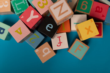Colorful alphabet blocks scattered on a blue surface a playful learning experience