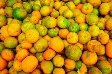 Orange citrus fruits in a fruit shop basket. Focus on fruit, noisy, exposure, similar others