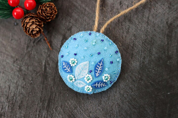 Handmade Christmas decoration  made of felt and seed bead. Black background with space for text. 