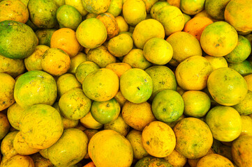 Orange citrus fruits in a fruit shop basket. Focus on fruit, noisy, exposure, similar others