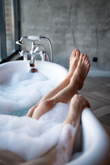 Woman feet in bathrobe at home, closeup